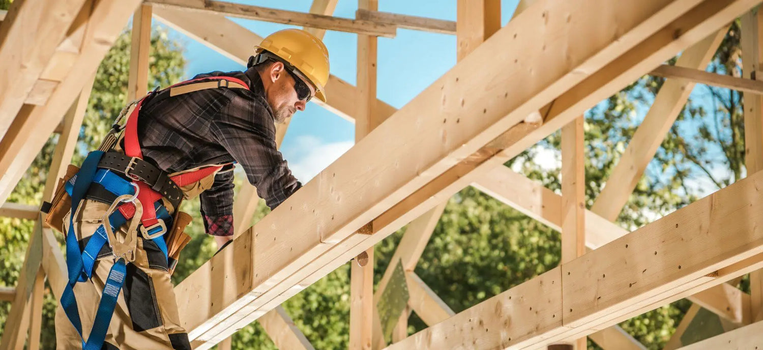 man with tool belt framing lumber