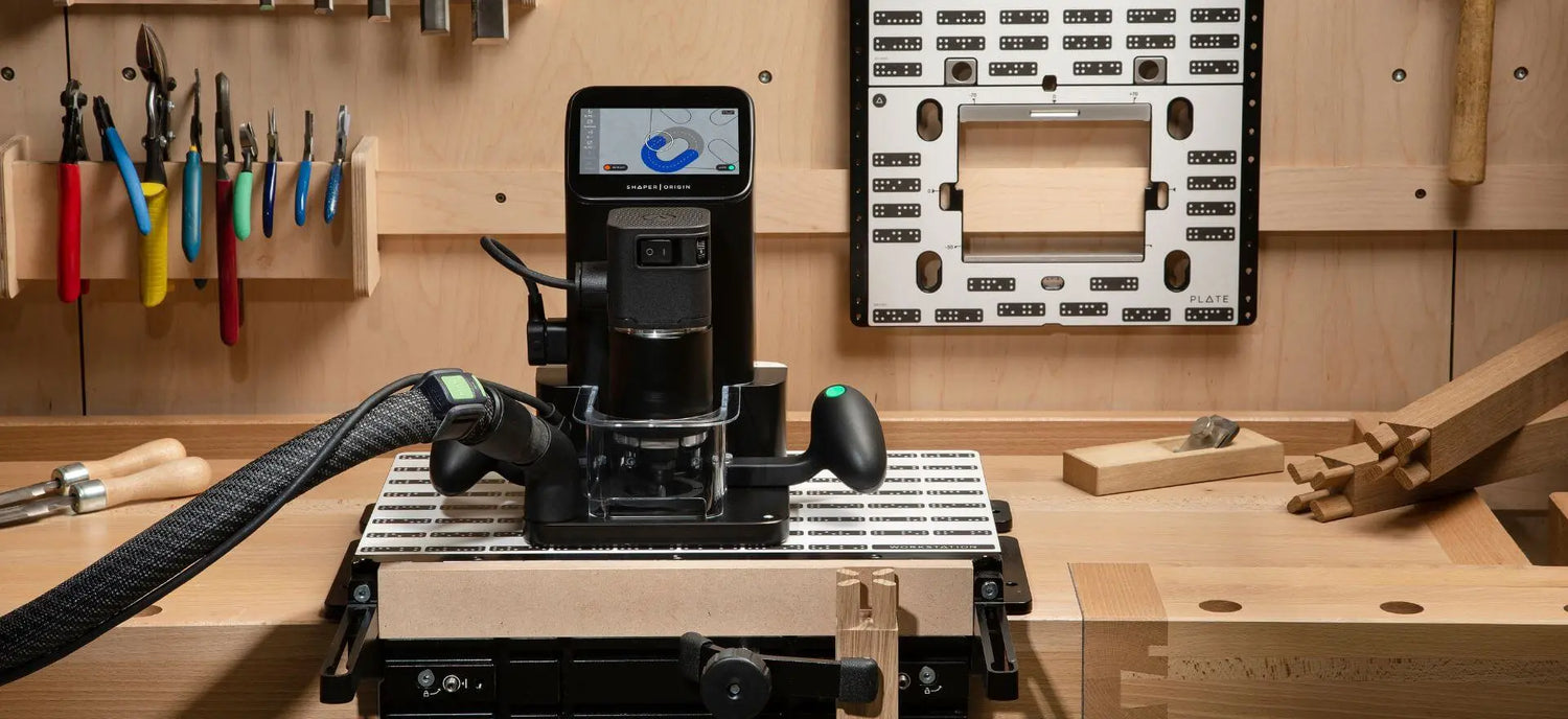 Shaper Origin Handheld CNC Router with Hose on Workstation