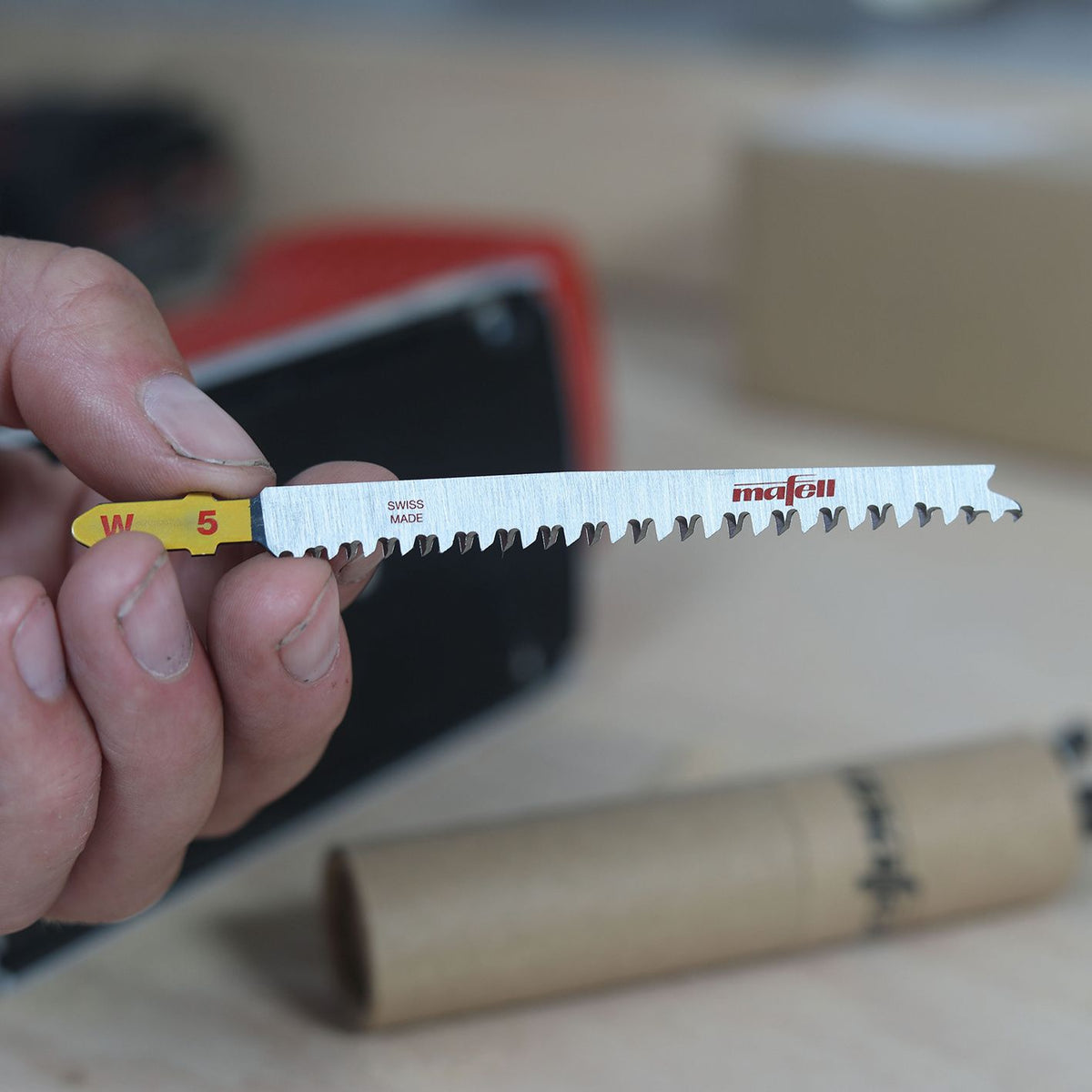 Person holds Mafell W5 wood jig saw blade with yellow W5 label