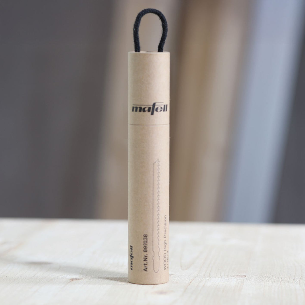 Mafell blade packaging tube upright with a black loop on a workshop surface
