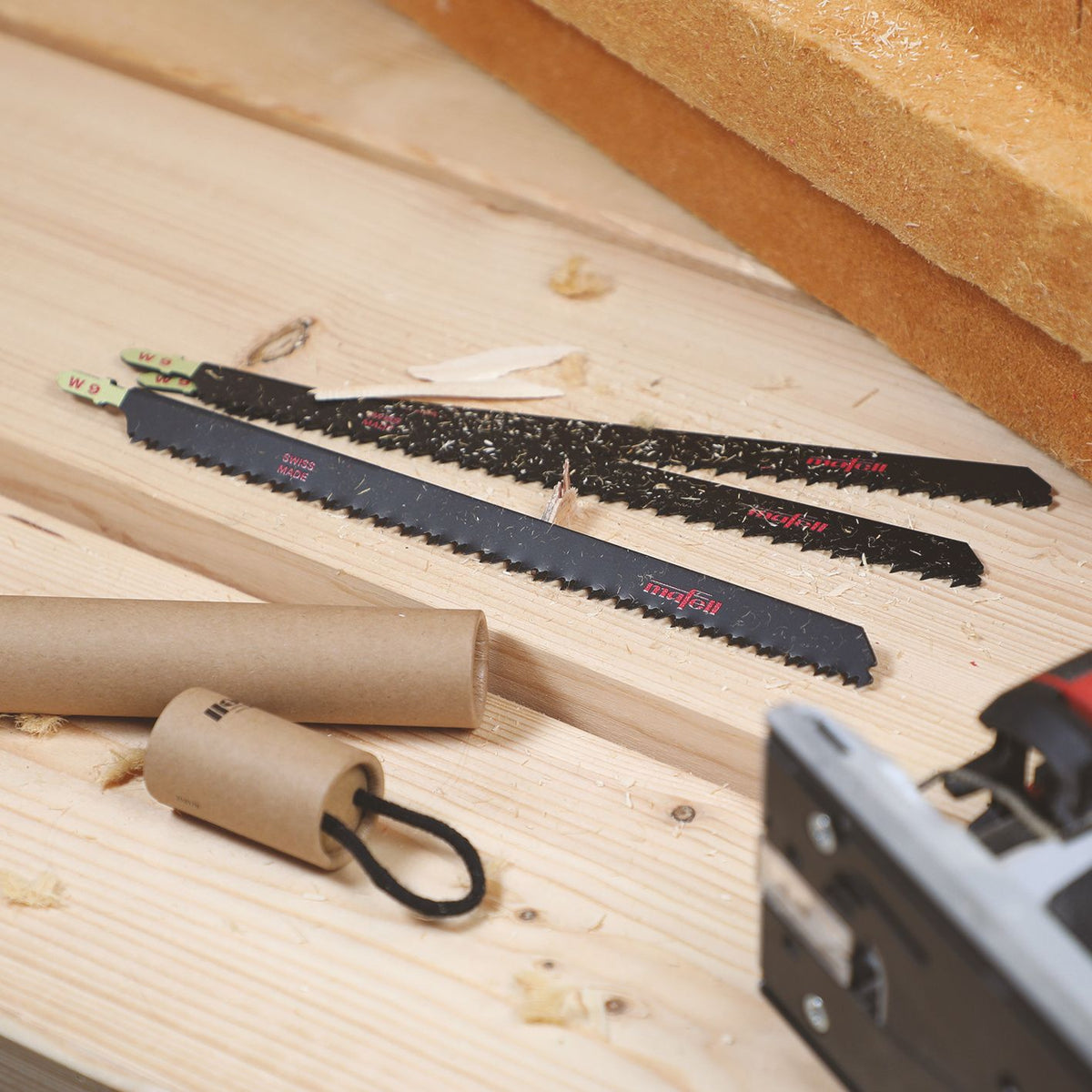 Three Mafell SSB-W9 wood precision jig saw blades 220 mm 3-pack laid on a wooden work surface