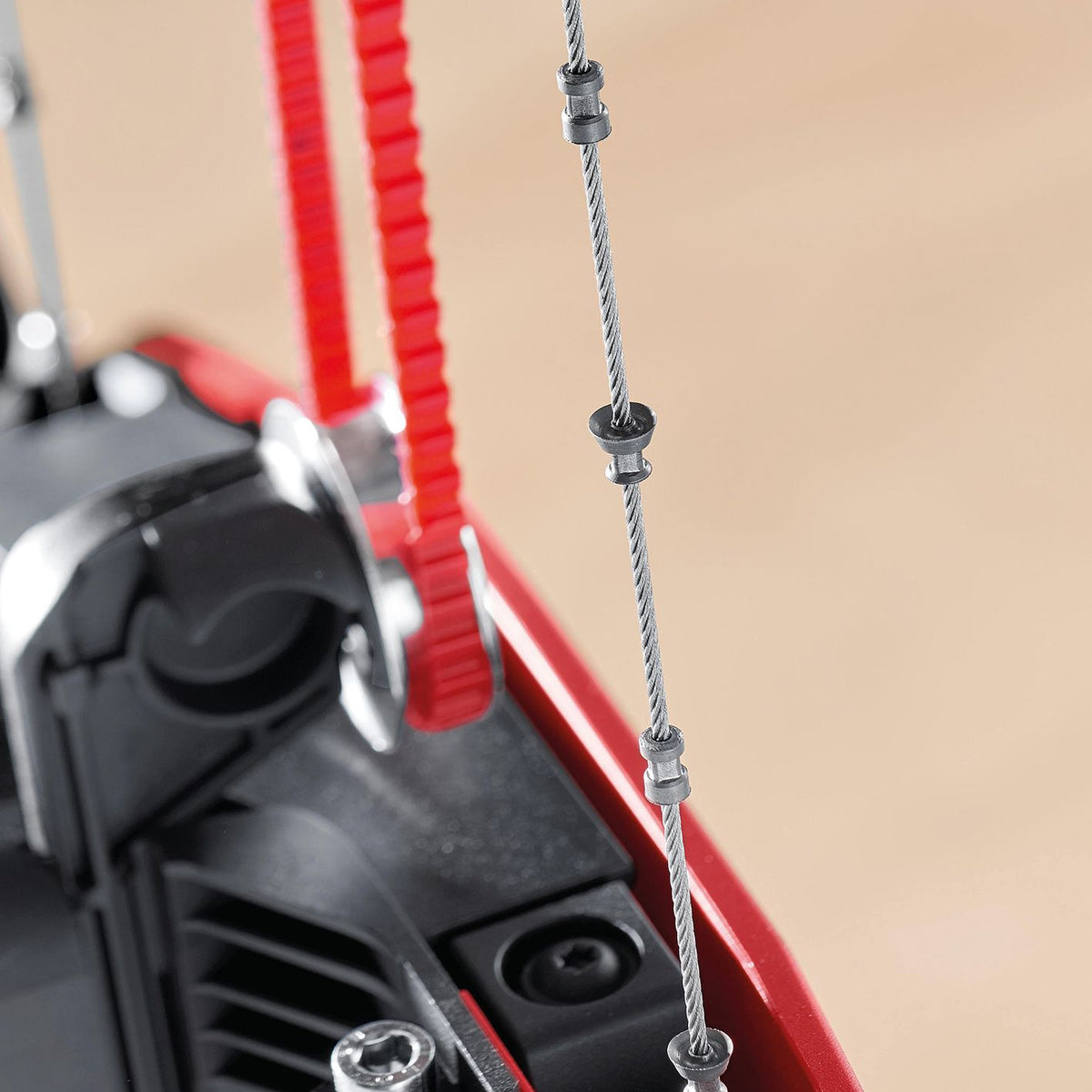 Close up of Mafell Cutting Wire DSS-SR with clamps on the wire and a red guide in the saw housing
