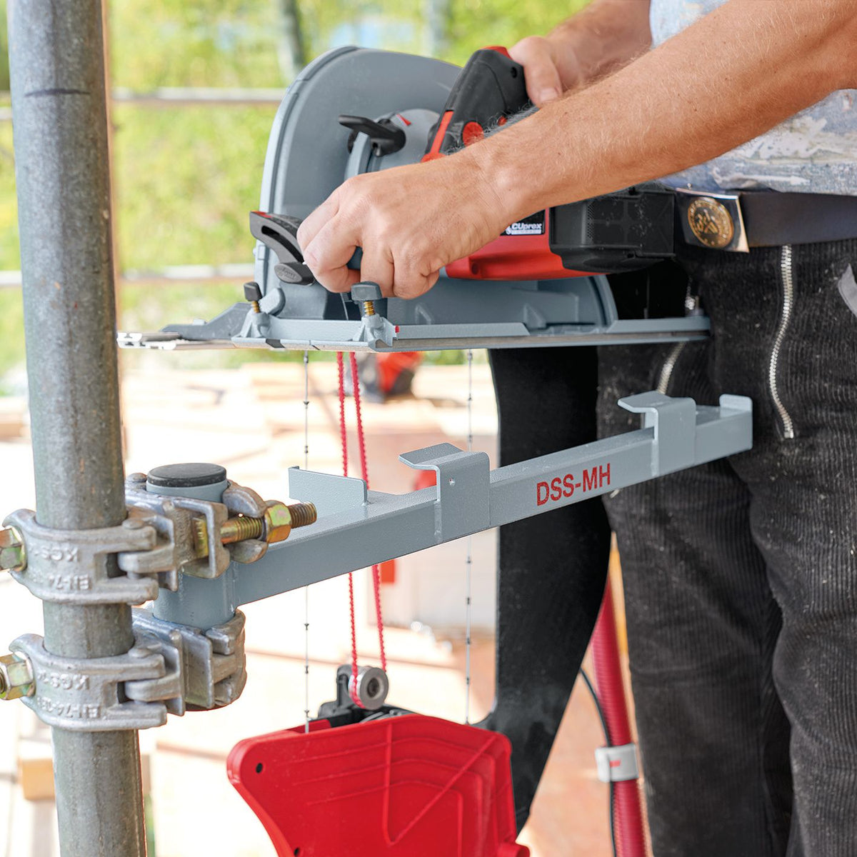 Mafell S 200 MH machine holder attached to a scaffold pole securing the red DSS 300 insulation saw.