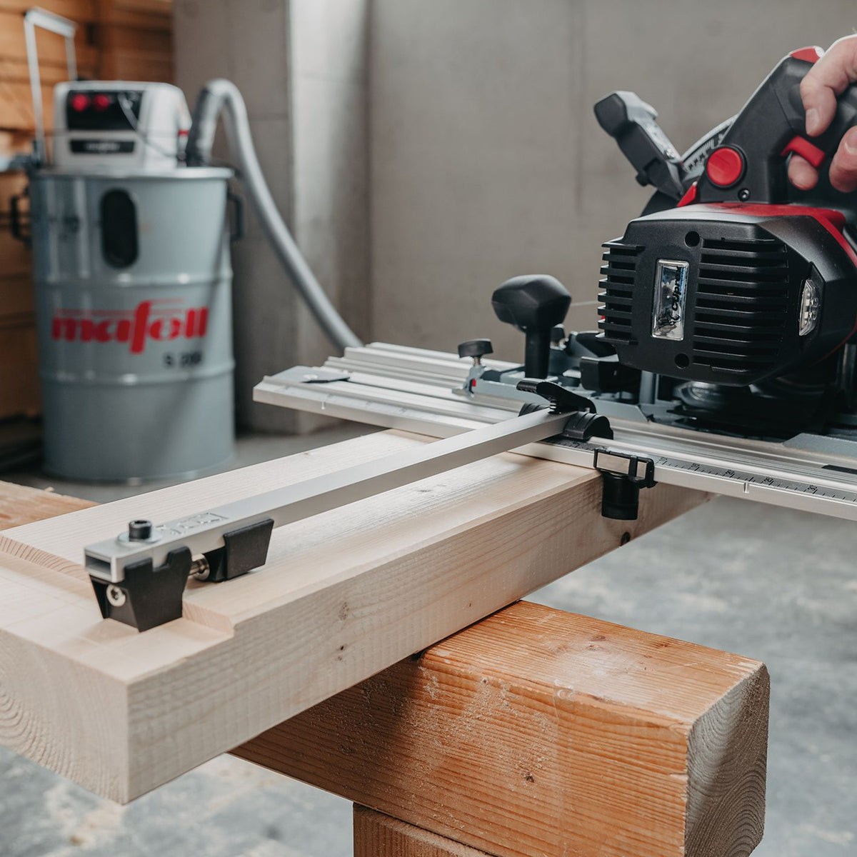 Mafell side fence in use on a straightedge guide with a router in a woodworking setup