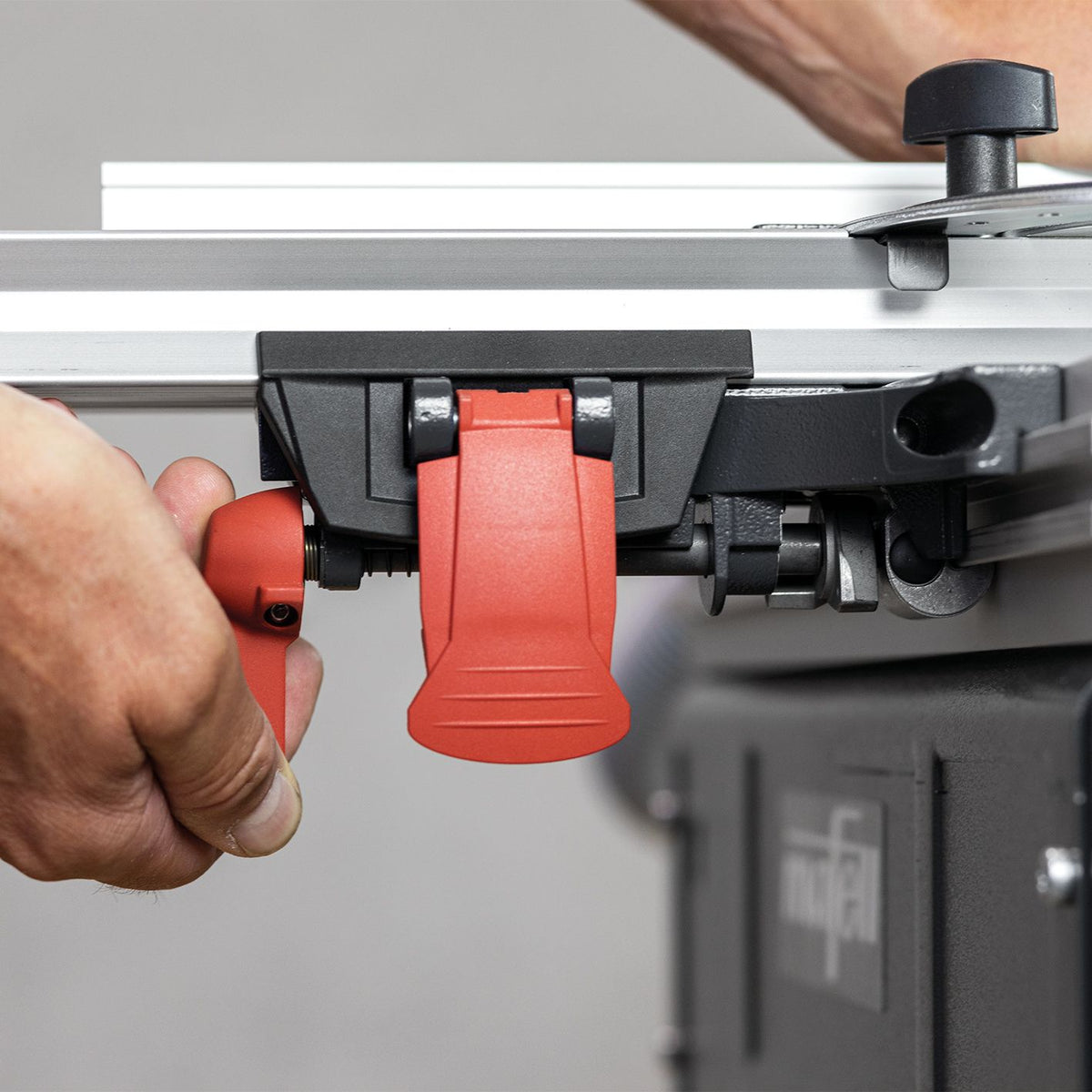 Close up of Mafell Clamping Fence Support for ERIKA 60 being adjusted by hand along the table edge