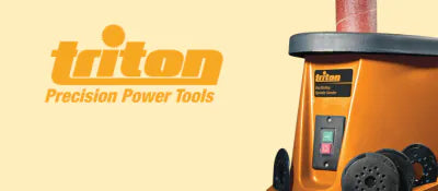 Orange power tool with Triton branding on a beige background