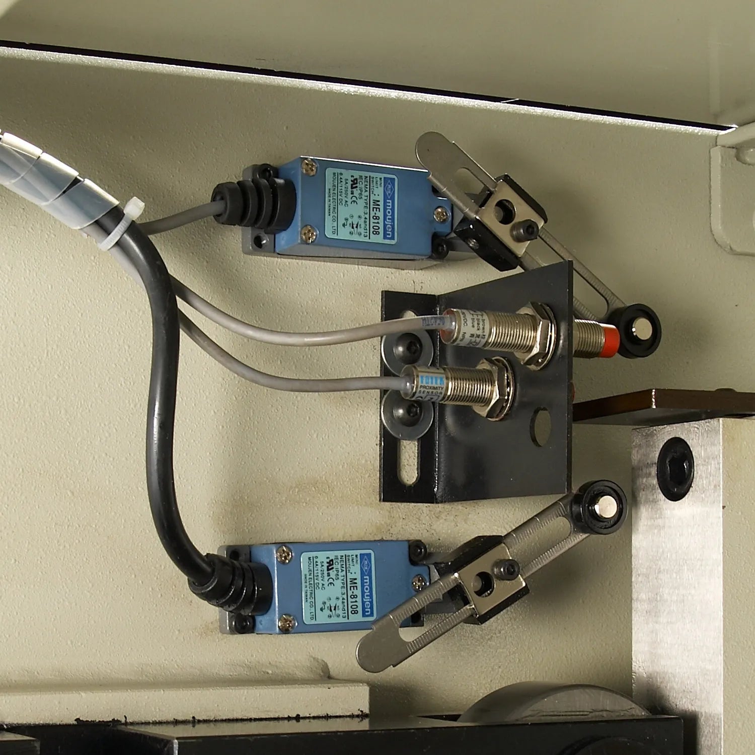 Close up of Baileigh SH-8010-HD control area with blue electrical components and wiring mounted to the frame.