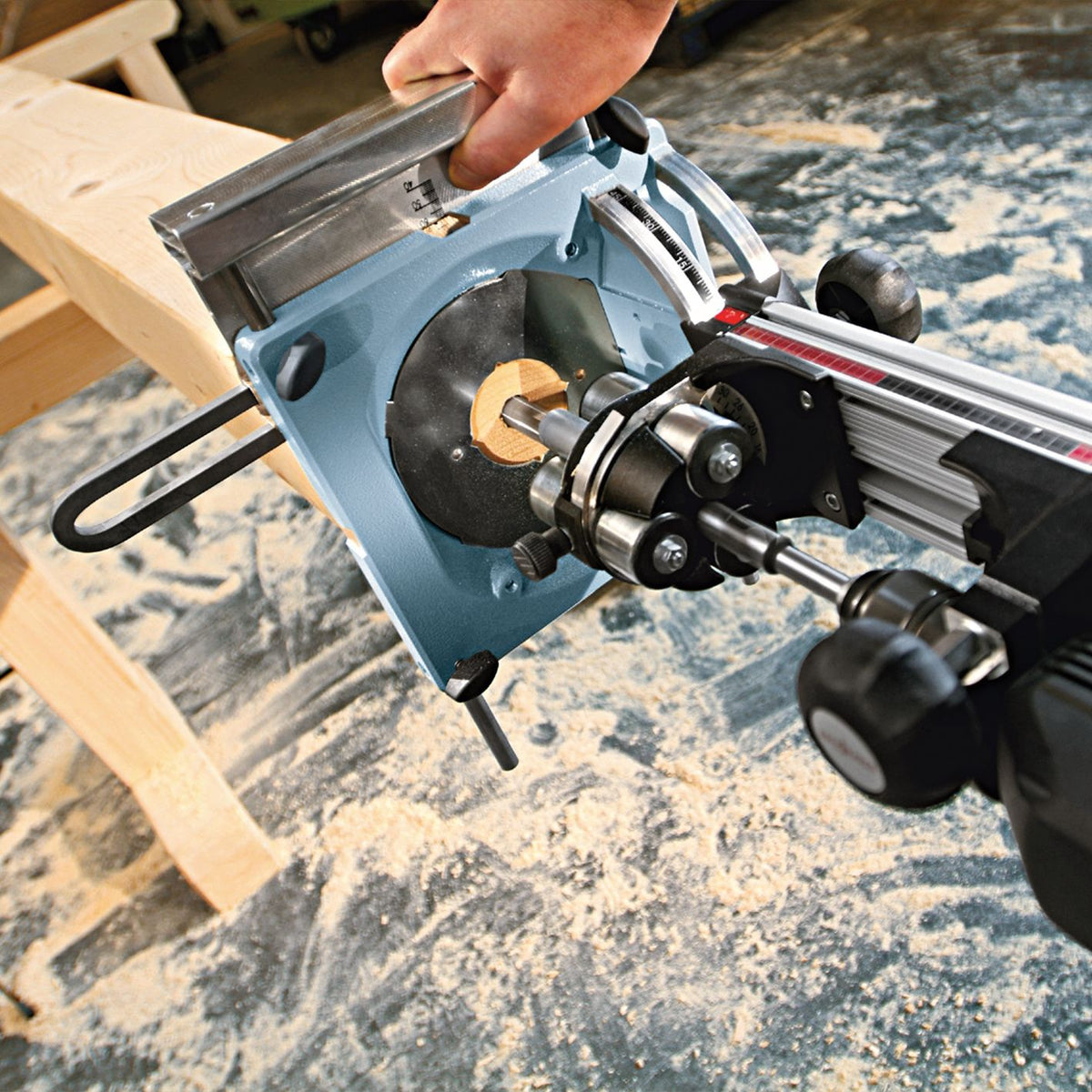 Hands operate a Mafell BST drilling station with parallel guide fence and edge stop for precise hole spacing