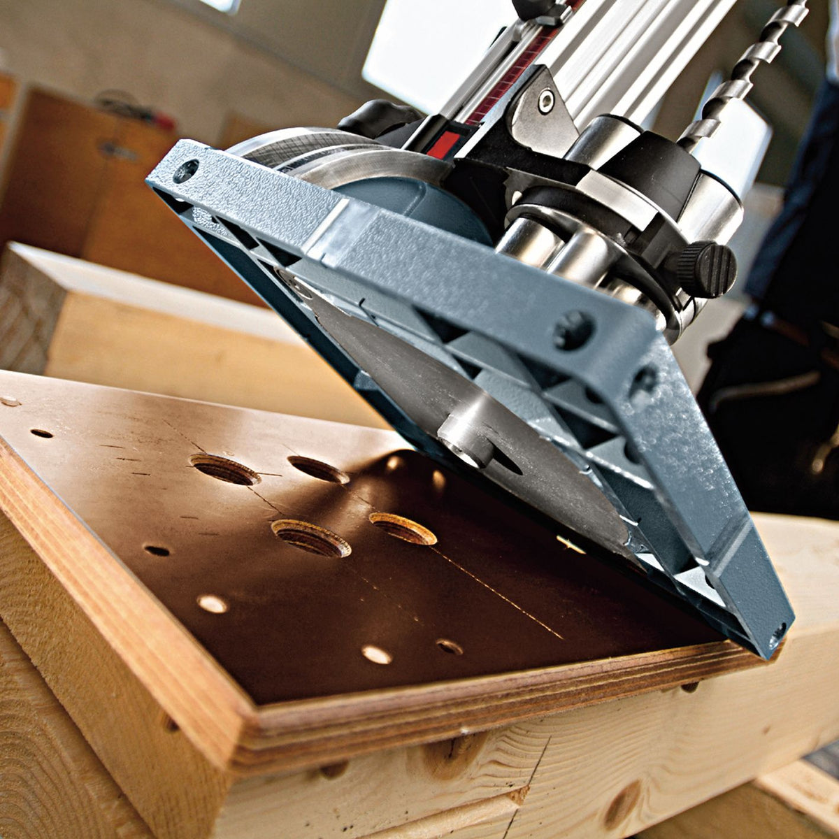 Mafell copying insert installed on a BST drilling station guiding precise hole drilling into a wooden workpiece.