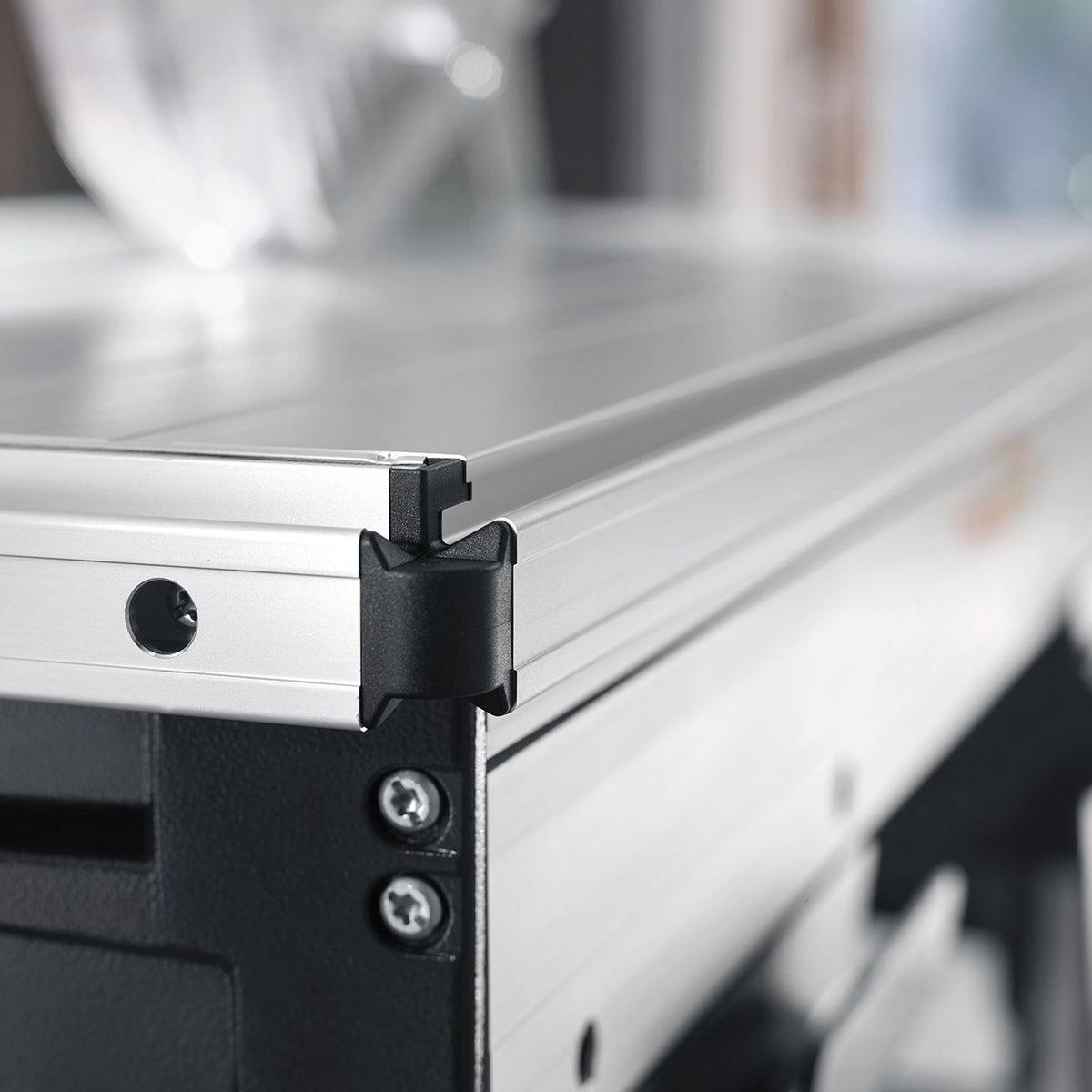 Front edge of Mafell extension table showing the black corner stop mounted on the aluminum rail.