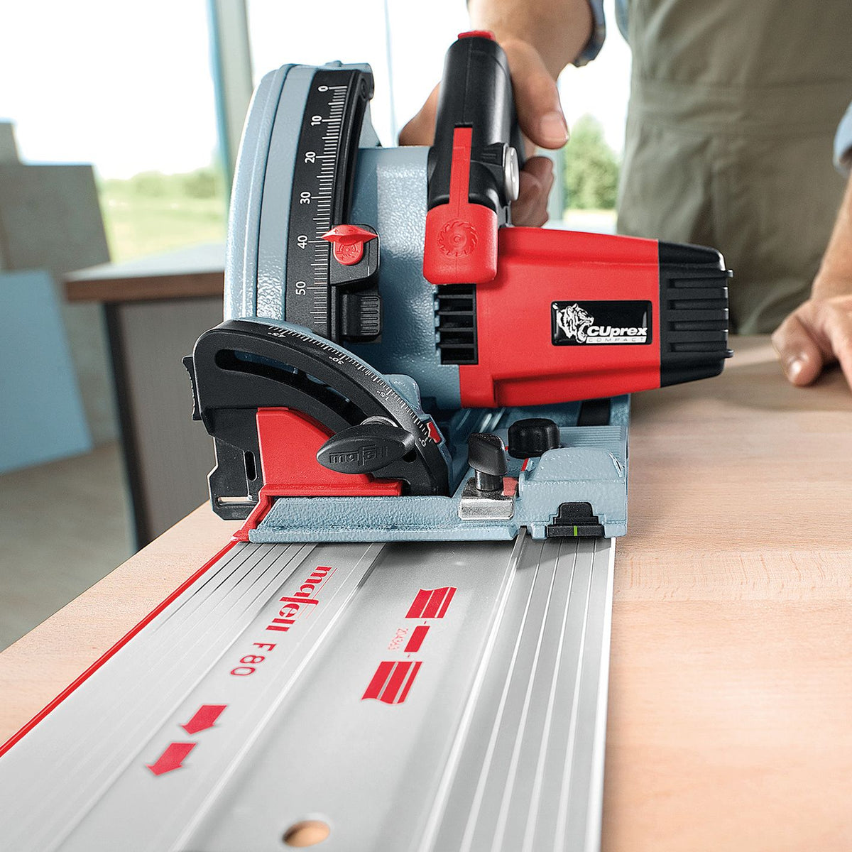 Hands adjust the Mafell F 80 guide rail showing the vertical measurement scale on the side