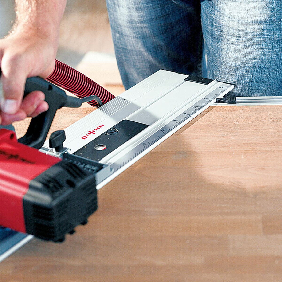 Mafell F-WA angle fence clamped to F-System guide rails with a power saw guiding a cut on a wooden board.