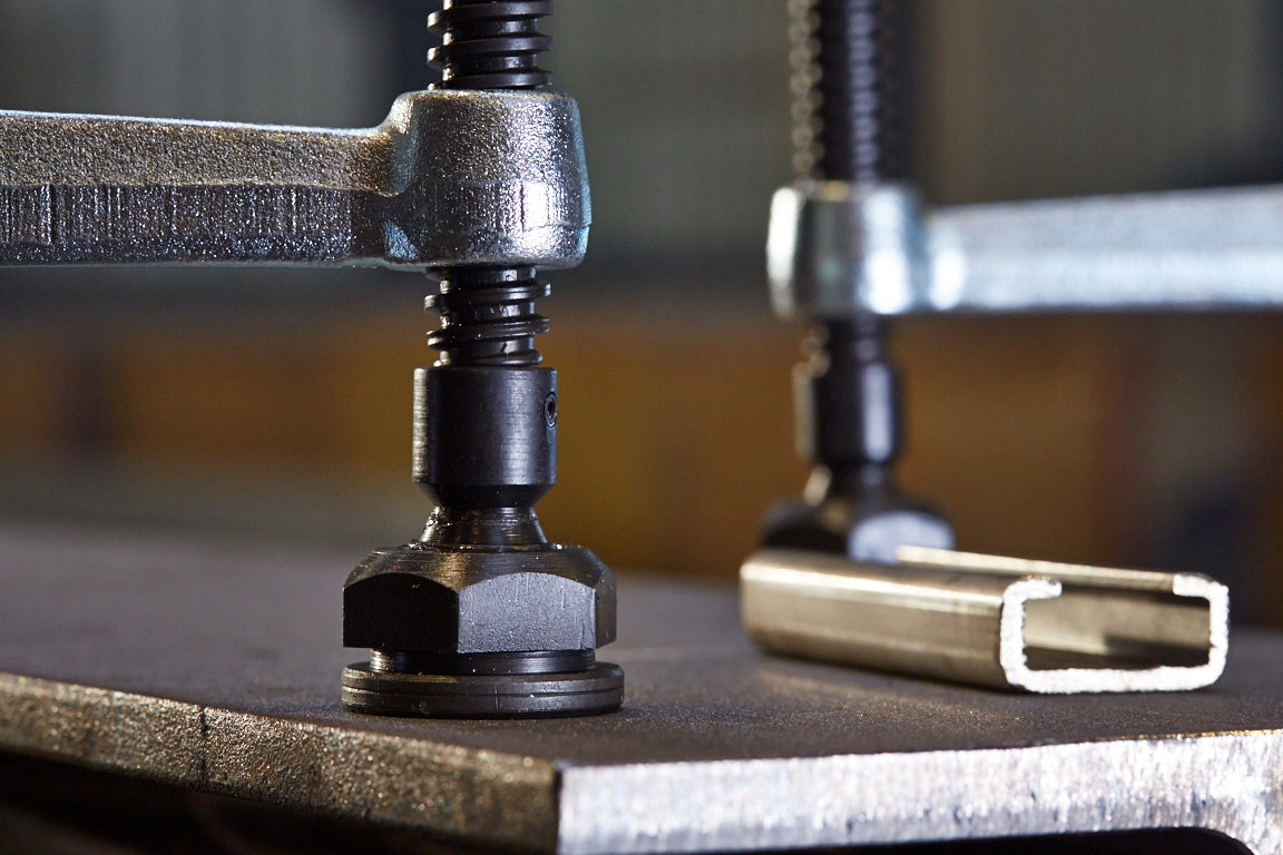 Close-up of a Bessey GSL60 F-style welding clamp tightening onto a metal channel