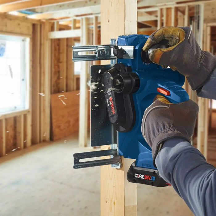 Person using a Bosch power tool on a wooden frame