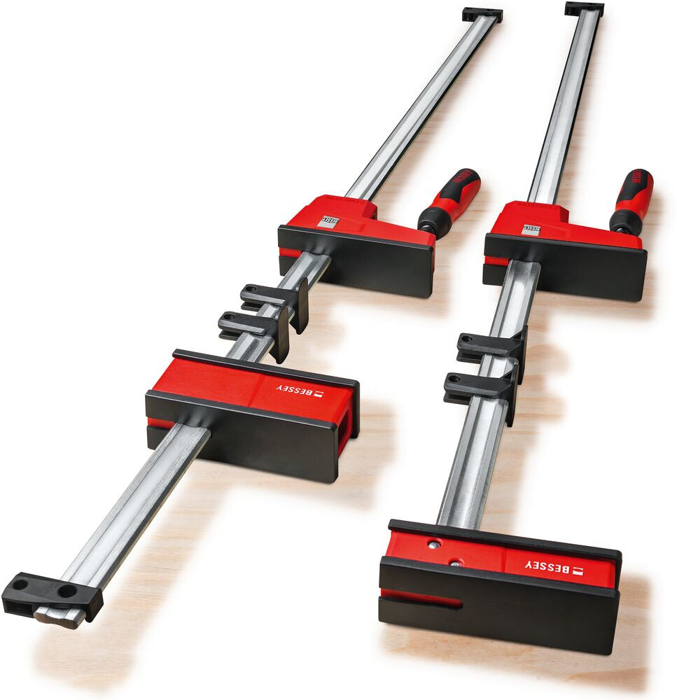 Two red Bessey K Body REVO parallel clamps mounted on long silver rails