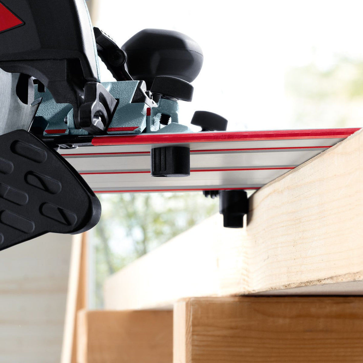 Mafell Guide Track M 400 mm mounted on a workbench with red rails and a clamping knob