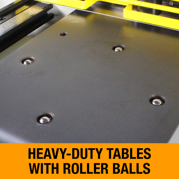 Close-up of a dark metal worktable with multiple roller balls for easy material handling.