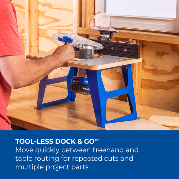 Woodworker uses Kreg Dock & Go Trim Router Table on a blue stand to guide a piece of wood across the table