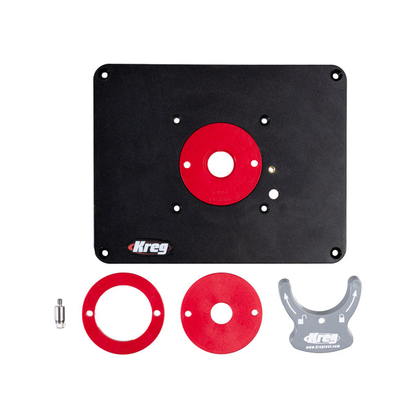 Kreg router table insert plate kit laid out with red rings and a grey alignment wrench
