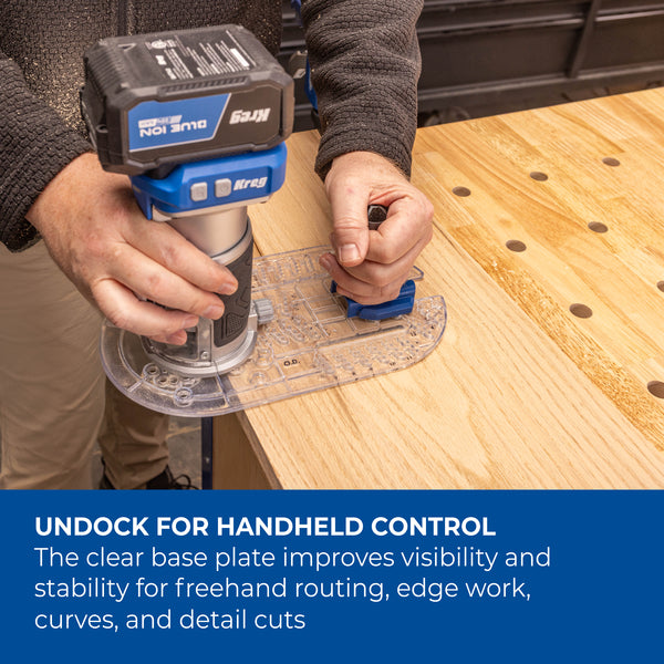Close-up of a blue Kreg trim router with a clear base plate mounted on a router table.