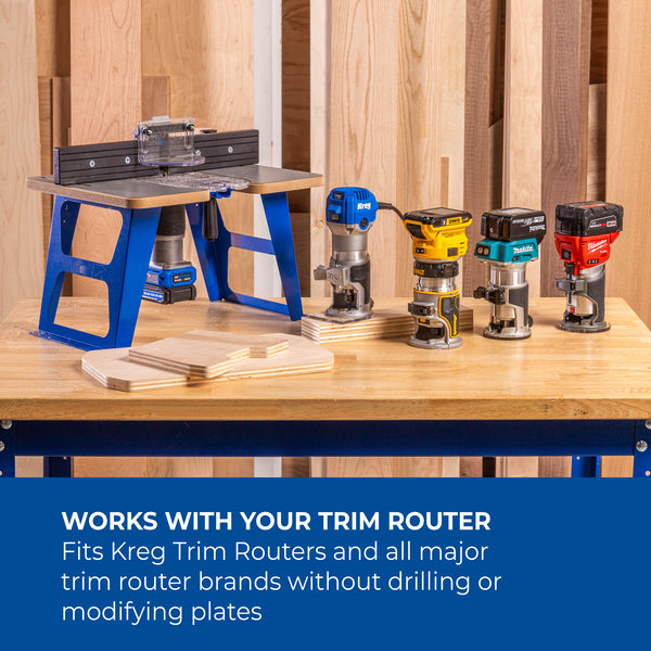 Wide view of the trim router table on a blue stand with a row of cordless drills on the bench showing versatility