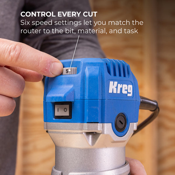 Close-up of blue Kreg trim router showing speed setting dial and on/off switch
