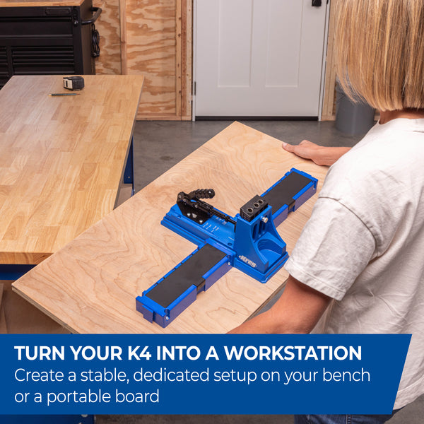 Person uses the blue Kreg K4UP workstation on a bench to place a long board for drilling