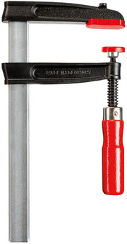 Close up of a Bessey TC5.512 F-style woodworking clamp with flat rail and red handle.